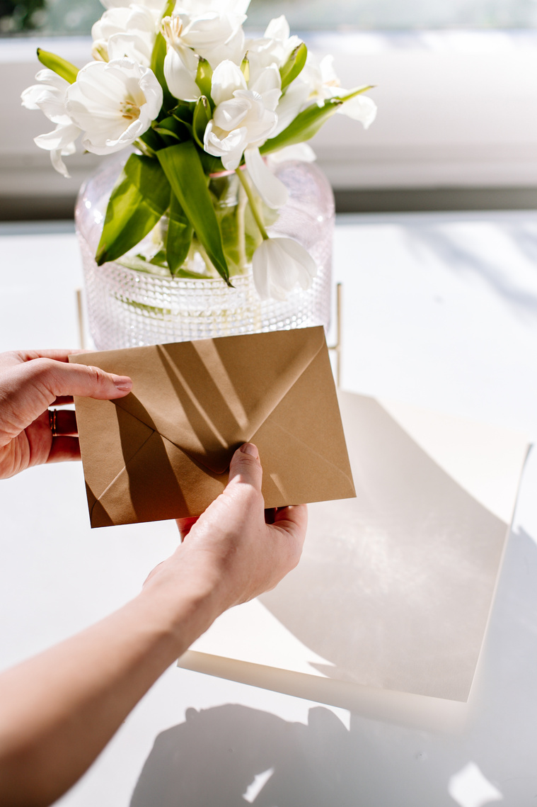 Hands Holding an Envelop on the Table 